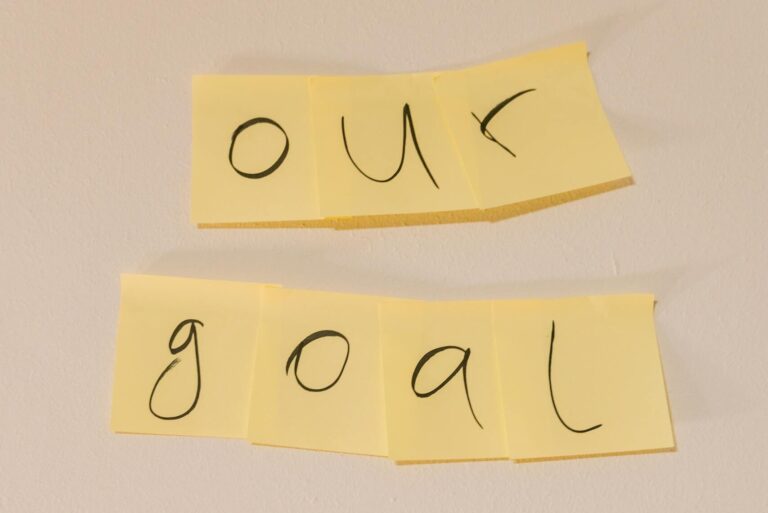 Sticky notes with the text 'our goal' on a wall emphasizing objectives.